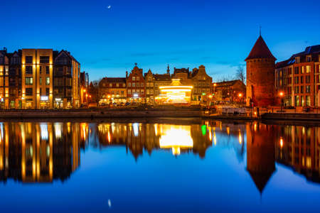Gdansk, Poland - April 3, 2022: Scenery of the old town in Gdansk reflected in the Motlawa river at dusk, Poland.のeditorial素材
