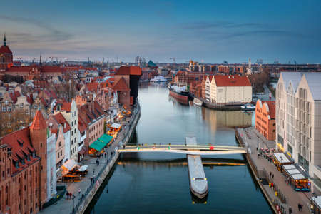 Gdansk, Poland - April 3, 2022: Historic port crane in Gdansk reflected in the Motlawa river at dusk, Polandのeditorial素材
