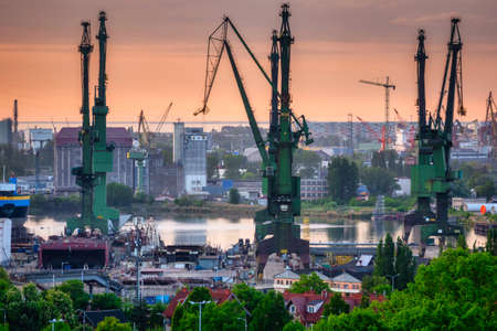 Shipyard cranes in Gdansk at sunset. Polandの写真素材