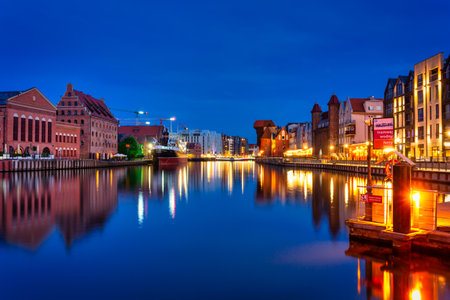 Gdansk, Poland - May 31, 2022: Beautiful Gdansk city reflected in the Motlawa River with the ferry and ferris wheel at dusk. Polandのeditorial素材