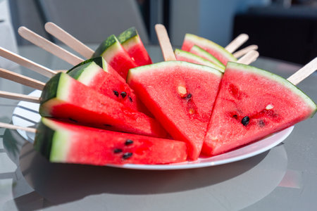 Watermelon slices on ice cream sticksの写真素材