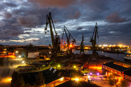 Gdansk, Poland - September 2, 2022: Gdansk shipyard scenery (Stocznia or 100cznia in polish means shipyard) with retro-lighted clubs and bars at dusk, Poland.のeditorial素材