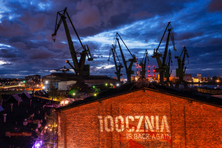 Gdansk, Poland - September 2, 2022: Gdansk shipyard scenery (Stocznia or 100cznia in polish means shipyard) with retro-lighted clubs and bars at dusk, Poland.のeditorial素材
