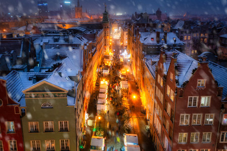 Beautifully lit Christmas fair in the Main City of Gdansk during a snowfall. Polandの写真素材