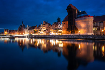 Old town in Gdansk with historical port crane over Motlawa river at night, Poland.の写真素材