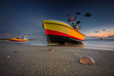 Fishing boats on the beach of Baltic Sea in Sopot at dusk, Polandの写真素材
