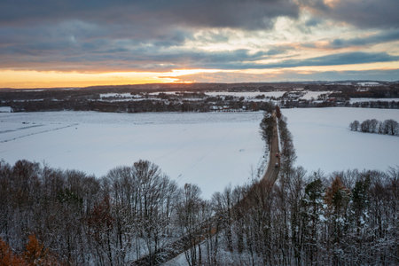 Aerial landscape of the road through snowy forest at winter, Poland.の写真素材