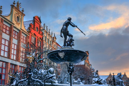 Sunrise in the historic center of Gdansk with the Neptune fountain at winter, Poland.の写真素材