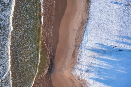 Beautiful scenery of Baltic Sea beach in Sobieszewo at snowy winter, Polandの写真素材