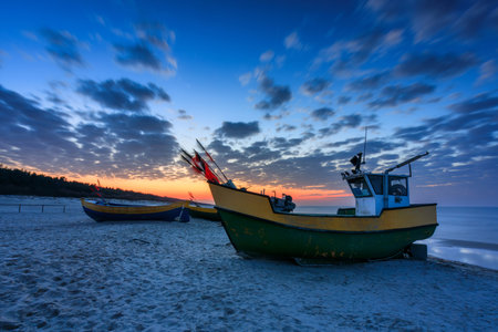 Fishing boats on the Baltic Sea beach in Jantar at sunset. Polandの写真素材