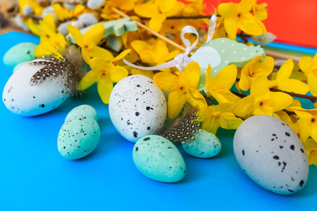 Composition of flowers, bunnies and Easter eggs on a pastel backgroundの写真素材
