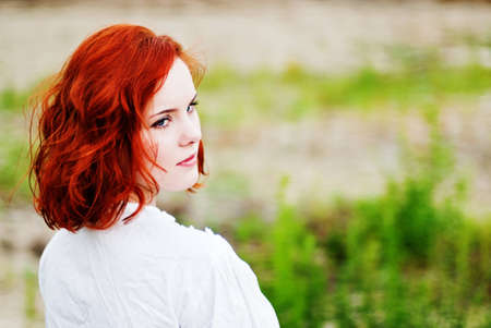 Beautiful young woman with red hairの写真素材