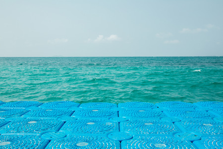 Blue buoys extended to the sea for mooringの写真素材
