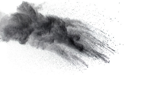 Black powder explosion. The particles of charcoal splatter on white background. Closeup of black dust particles splash isolated on  background.の写真素材