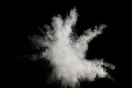 Launched white particle splash on black background. Bizarre forms of of white powder explosion cloud...
