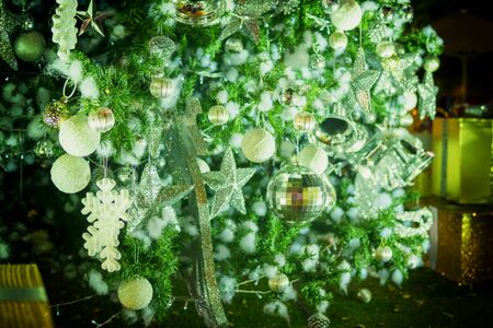 Blurred photo of Christmas lights. Festive New-year background with bokeh from Christmas tree lights glowing. Blurred colorful circles on light holiday background.の写真素材