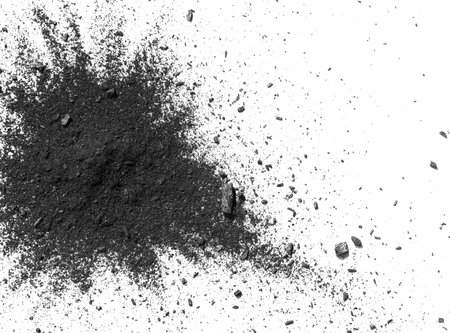 Closeup of black dust particles explode isolated on white backgroundの写真素材