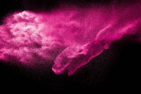 Pink dust particles splash on black