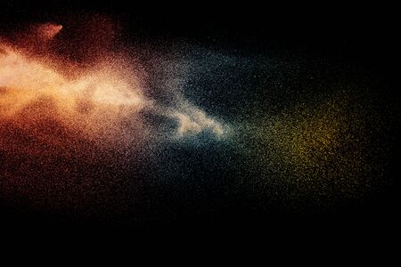 Blue orange particles explosion on black background.Colorful dust splash.