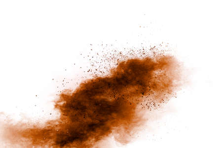 Brown dust exploding cloud.Brown particles splattered on white background.の写真素材