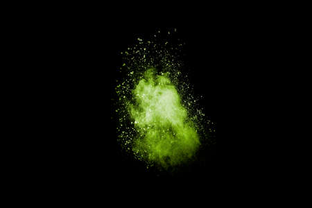 Abstract green dust explosion on black background. Green powder splattered.の写真素材