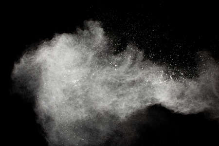 Freeze motion of white dust particles splash on black background.