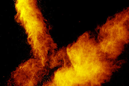 Red orange color powder explosion cloud isolated on black background.