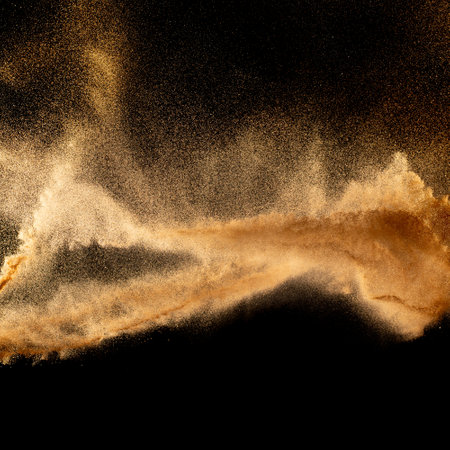 Sand explosion isolated on black background. Freeze motion of sandy dust splash.Sand texture concept.の写真素材