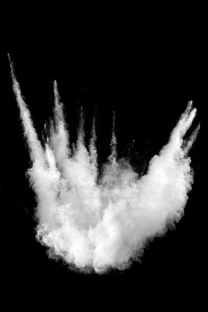 White powder explosion cloud against black background.White dust particles splash.の写真素材