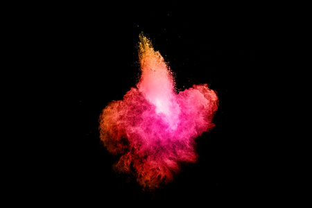 Explosion of pink colored powder isolated on black background.Pink dust splash.