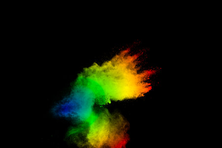 Explosion of colored powder isolated on black background.