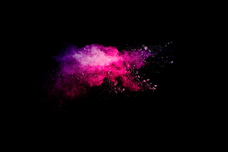 Explosion of pink colored powder isolated on black background.Pink dust splash.の写真素材