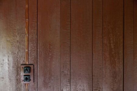 Brown Wood panel wall texture and old switch lightsの写真素材