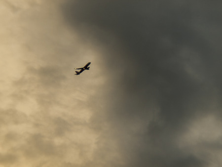 Clouds, blue sky , Planes flying in the sky / Planes flying in the sky while a rainstormの写真素材