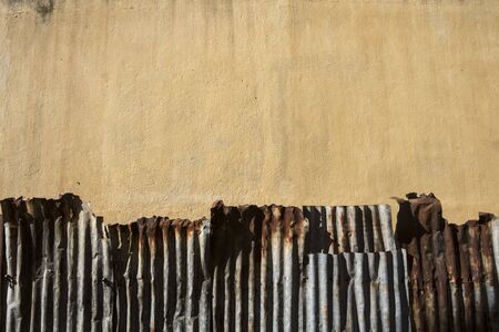 Old cement Wall yellow and zinc up rust wallpaperの写真素材