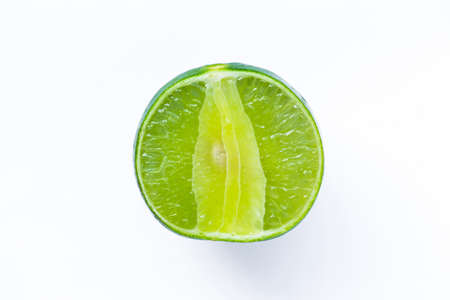 Limes with slices on wood backgroundの写真素材