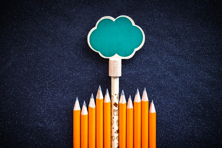 Orange pencils on blue leather textureの写真素材