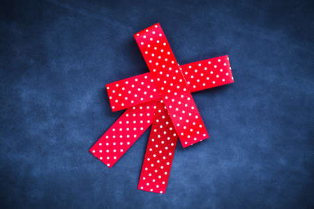 Christmas Red ribbon isolated on blue leather backgroundの写真素材