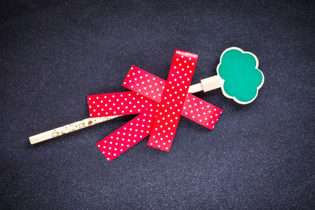 Christmas Red ribbon on pencil isolated on blue backgroundの写真素材