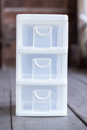 mini storage plastic box for office on wood backgroundの写真素材