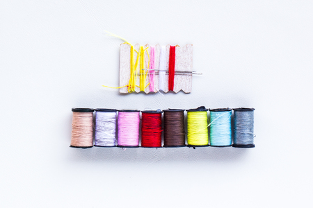mini thread colored spools on white backgroundの写真素材