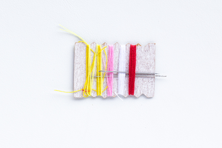 mini thread colored spools on white backgroundの写真素材