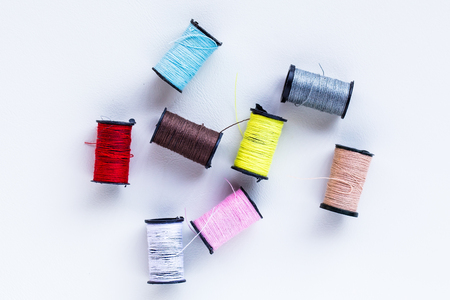 mini thread colored spools on white backgroundの写真素材
