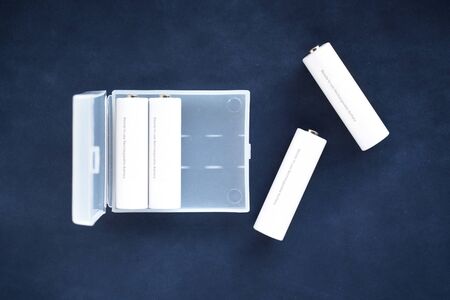 box AA size batteries isolated on blue whiteの写真素材