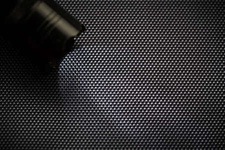Carbon fiber background,black texture with flashlightの写真素材