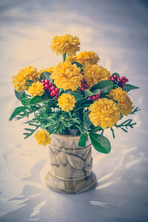vintage soft tone of Colorful flower bouquet arrangement centerpiece in vase ceramic.の写真素材