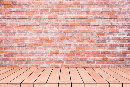 textured grey brick and stone wall with warm brown wooden floor inside old neglected and deserted interior, masonry and carpentry brickwork conceptの写真素材