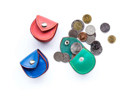 Closeup of coins and leather pocket purse. Isolated on white backgroundの写真素材