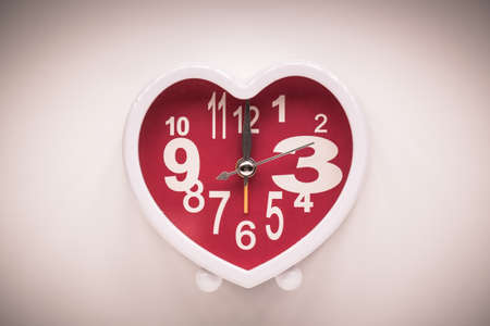 vintage heart clock on wooden backgroundの写真素材