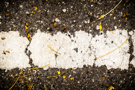 texture cracked asphalt road close to the long white line on the road side.の写真素材